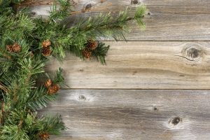 Rough Fir branches and cones on rustic wooden boards